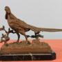 Bronze of a Golden pheasant in landscape