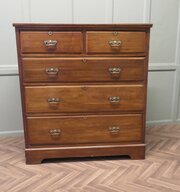 A Large Edwardian Walnut Chest Of Drawers   