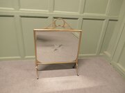 An Art Deco Brass And Sunburst Mirror Fire Screen