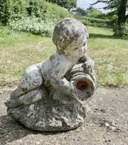 Garden Statue Of A Cherub Holding Urn Water Feature