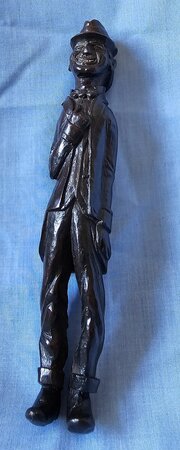 An Amusing Carved Mahogany Primitive Figure  A Grinning Man