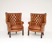 Pair Of Antique Leather Barrel Back Wing Armchairs