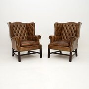 Pair Of Antique Leather Wing Back Armchairs