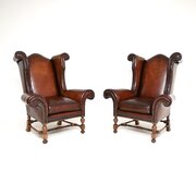 Pair Of Antique Leather Wing Back Armchairs