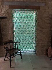 A Wall Of Large Green Cognac Bottles