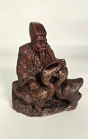 A Chinese carved stone figure of man feeding geese