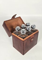 A Six Bottle Decanter Set In A Fitted Leather Case