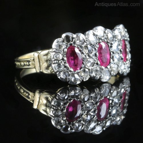 A Georgian era triple cluster diamond ring with rubies