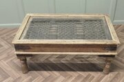 A Heavy Coffee Table With Inset Iron Grill Panel  