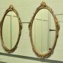 A Pair of Decorative Oval Gilt Wall Mirrors