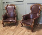 A Pair Of Victorian Leather Spoon Back Easy Chairs