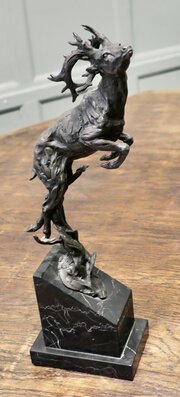 This is a Signed Bronze Sculpture of a Deer Jumpin