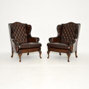 Pair Of Antique Leather Wing Back Armchairs