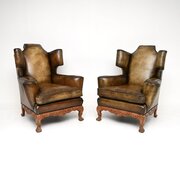Pair Of Antique Leather Wing Back Armchairs