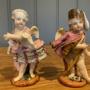 Pair of Augustus Rex Figures of Cupid in Disguise