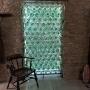 A Wall Of Large Green Cognac Bottles