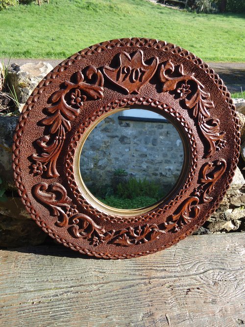 Arts & Crafts circular carved mirror dated 1907