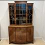 Maple & Co bow front bookcase on cabinet